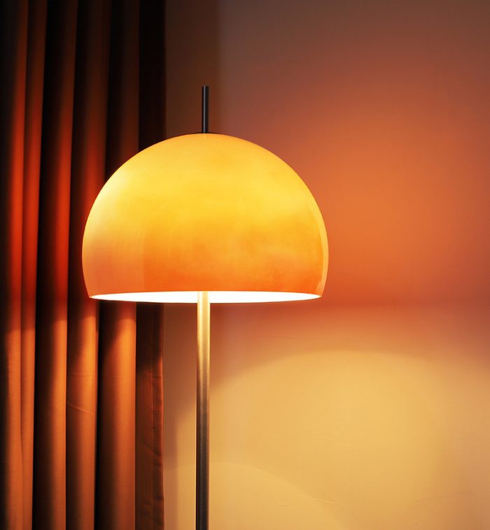 modern orange floor lamp dimly lit